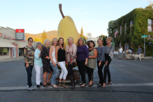 Group of 10 women standing in front of the festivals giant pear