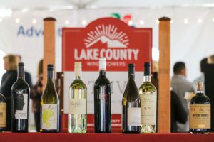 Bottles of wine in front of the Lake County sign