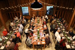 People eating in a barn.